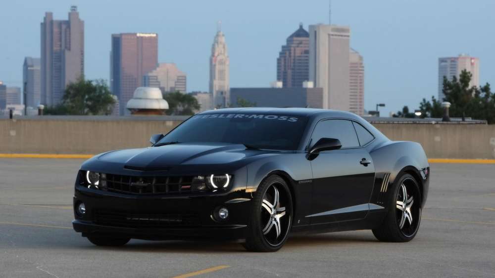 Black Muscle Car in Urban Landscape wallpaper