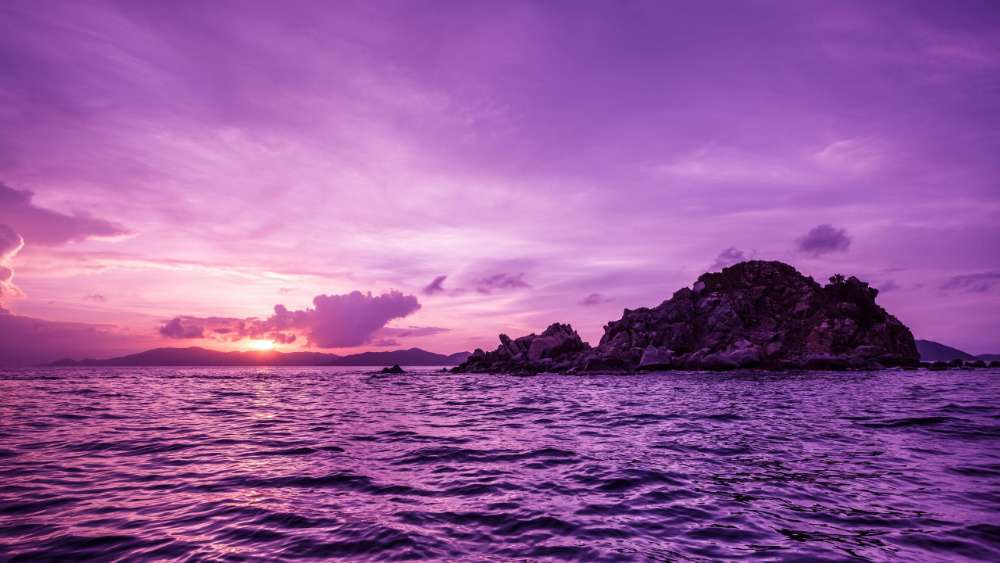 Majestic Purple Sunset Over Serene Island wallpaper