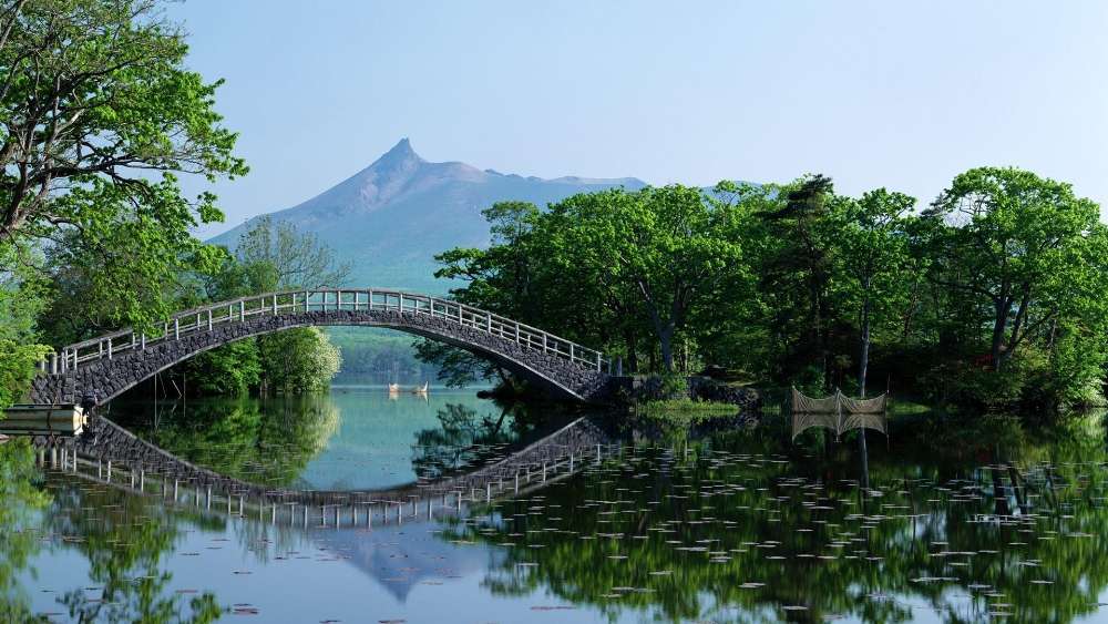 Serene Arch Bridge over Tranquil Waters wallpaper
