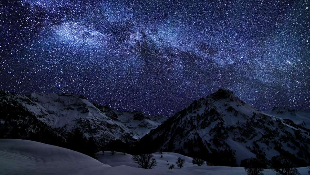 Starry Night Over Snow-Capped Peaks wallpaper