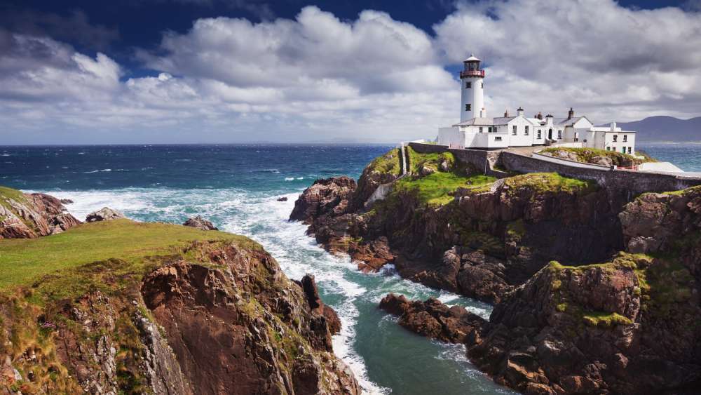 Majestic Lighthouse Overseeing Turbulent Seas wallpaper