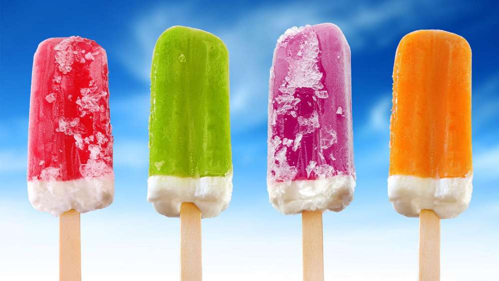 Colorful Ice Lollies Against Blue Sky wallpaper