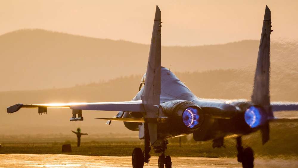 Sukhoi Su-27 Fighter Jet Against Sunset Glow wallpaper