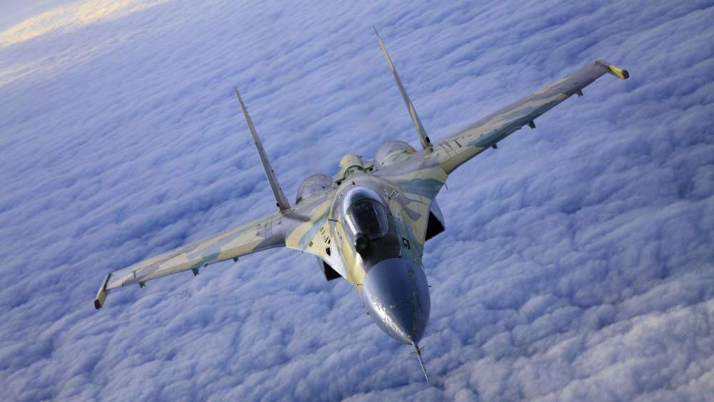 Soaring Combat Jet Above Clouds wallpaper