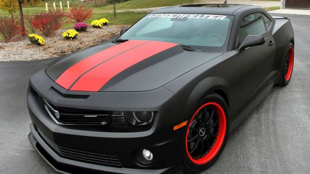 Sleek Black Camaro with Red Stripes wallpaper