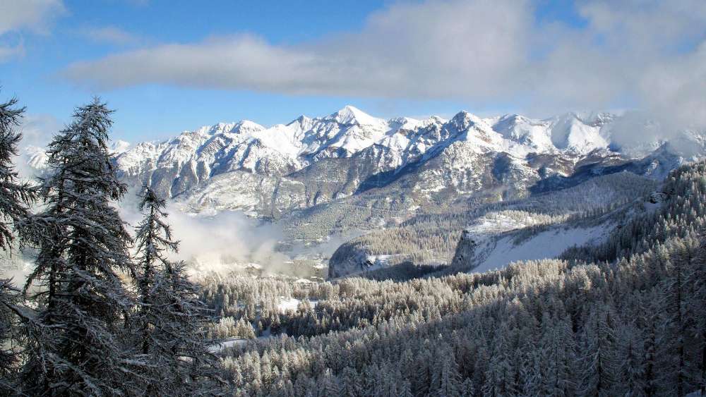 Majestic Snow-Capped Mountains Under Bright Blue Sky wallpaper