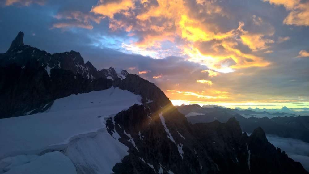 Sunset Over Snowy Mountain Peaks wallpaper