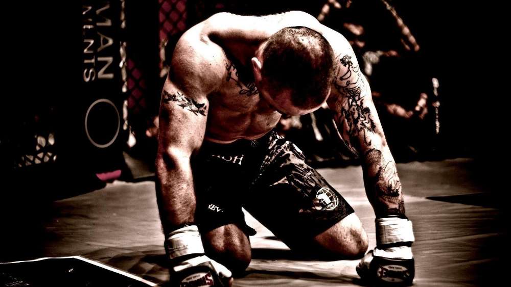 Intensity in Defeat MMA Fighter Contemplation wallpaper