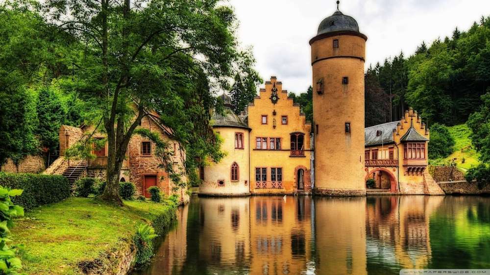 Majestic Castle by Serene Lake in Forest Setting wallpaper