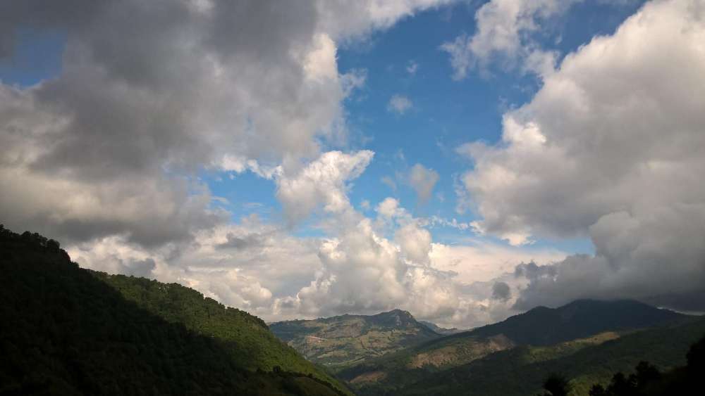 Majestic Mountains Under Dynamic Skies wallpaper