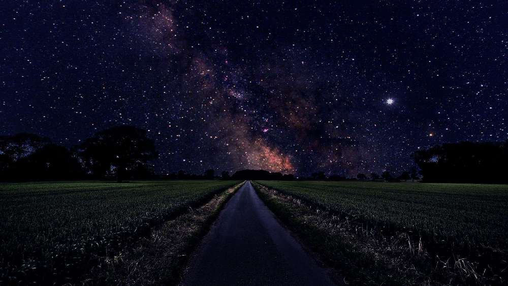 Starry Night Over Tranquil Countryside Road wallpaper