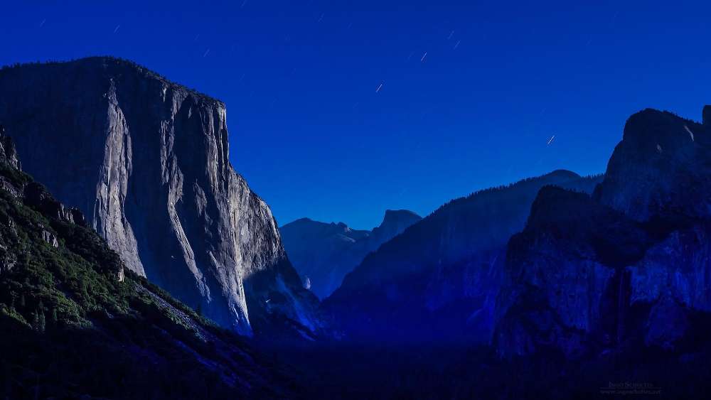 Starry Night Over Majestic Cliffs and Peaks wallpaper