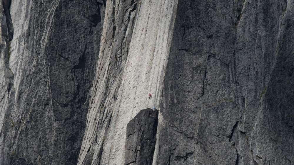 Huge cliff with a climber wallpaper