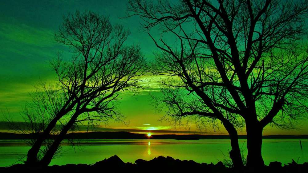 Emerald Sunset Over Tranquil Lake wallpaper