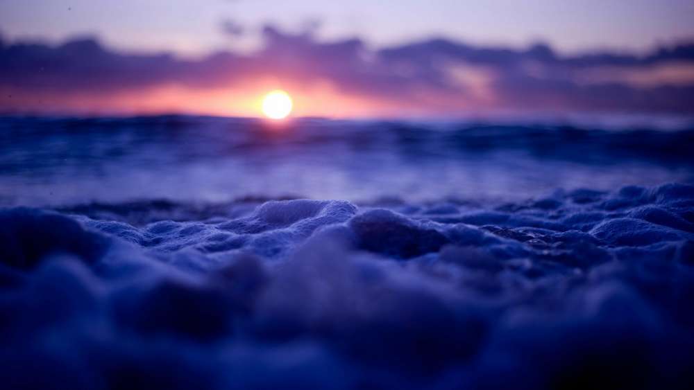Foamy Waves Under a Purple Sunset wallpaper