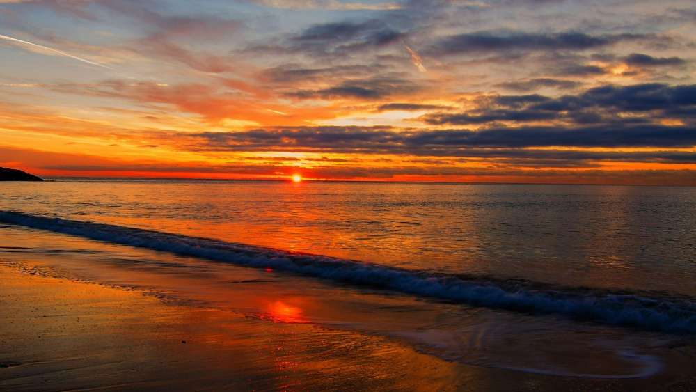 Sunset Over a Tranquil Beach wallpaper