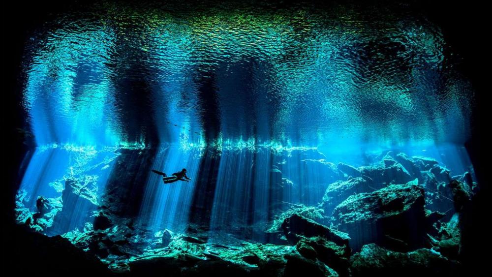 Mystical Underwater Cave Exploration wallpaper