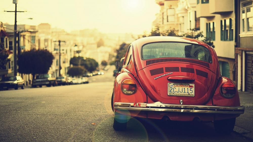 Vintage Volkswagen Beetle Basking in Sunset wallpaper