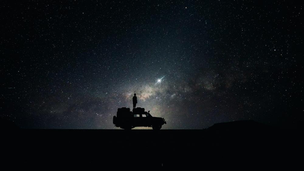 Stargazer's Serenity Beside a Lone Vehicle wallpaper