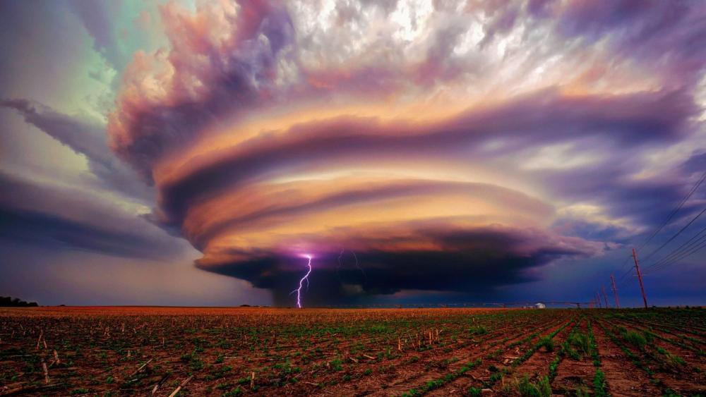 Majestic Storm Unleashing Fury on Fields wallpaper