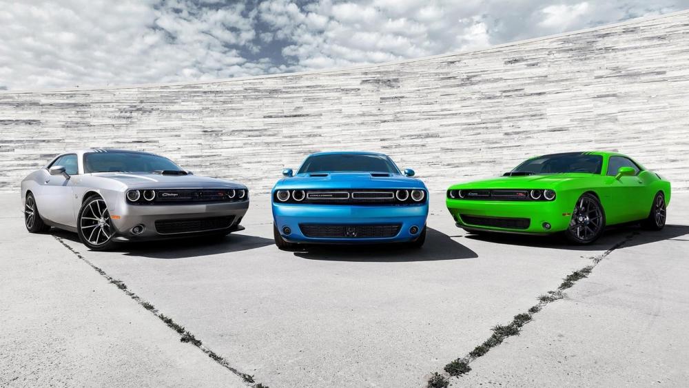 Impressive Vintage Car Trio Displaying Style and Power wallpaper