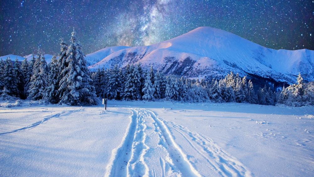 Milky way on the night sky over the snowy mountains wallpaper