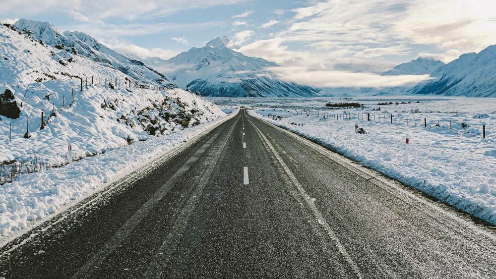Road towards the snowy mountains wallpaper