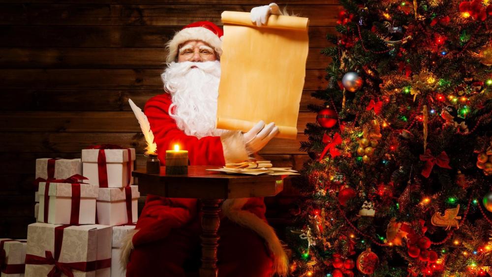 Santa Claus beside the Christmas tree wallpaper