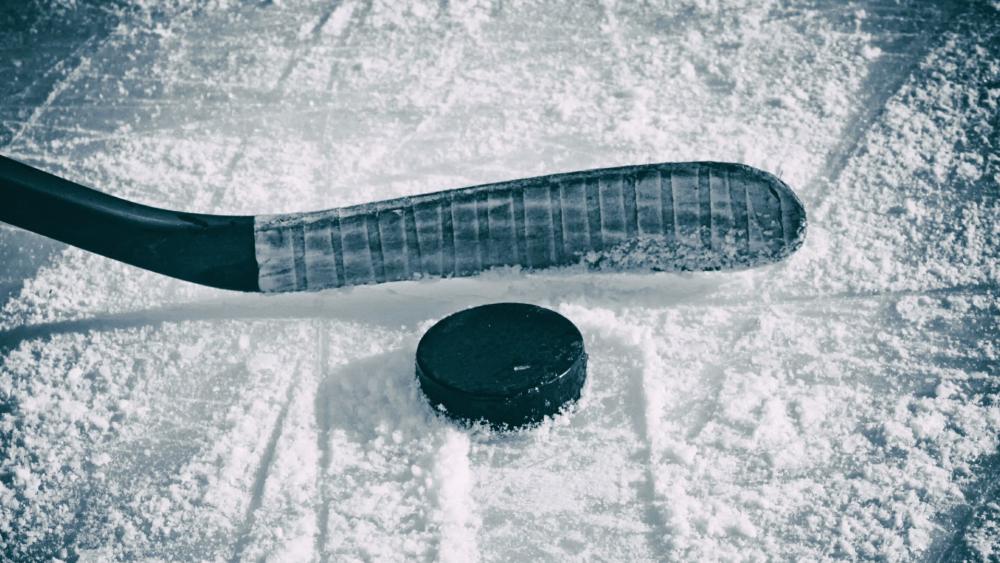 Hockey stick and puck on the ice wallpaper