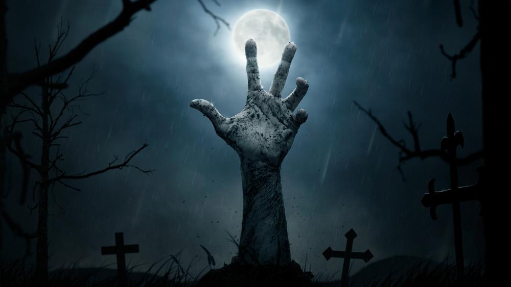 Creepy night cemetery with a zombie hand wallpaper
