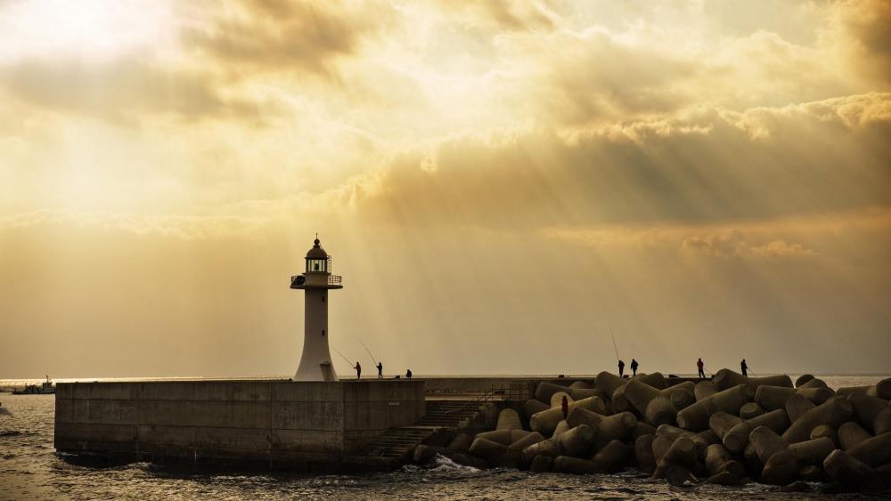 Lighthouse in the sun rays wallpaper