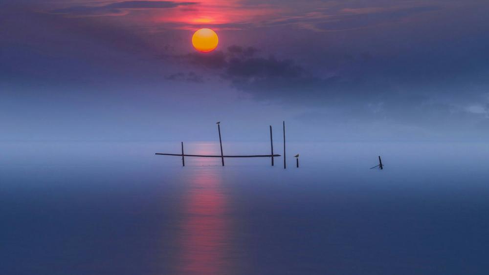 Sunset over the misty sea wallpaper
