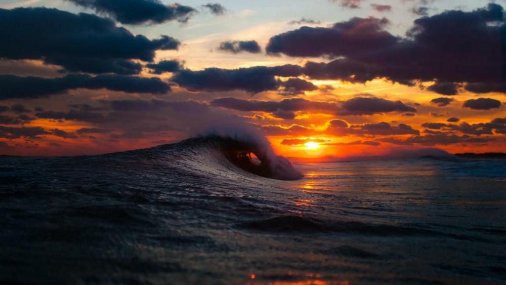 Ocean wave in the sunset wallpaper