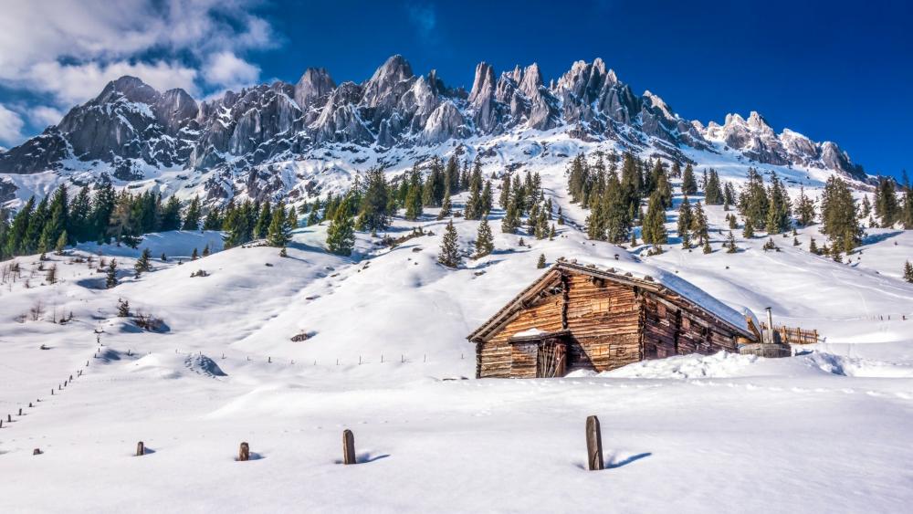 Snowy log cabin in Dolomites wallpaper