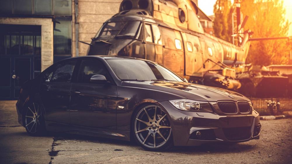 Black BMW E90 with a helicopter wallpaper