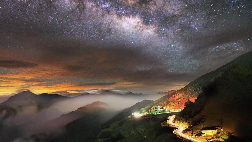 Milky way over the mountain road wallpaper