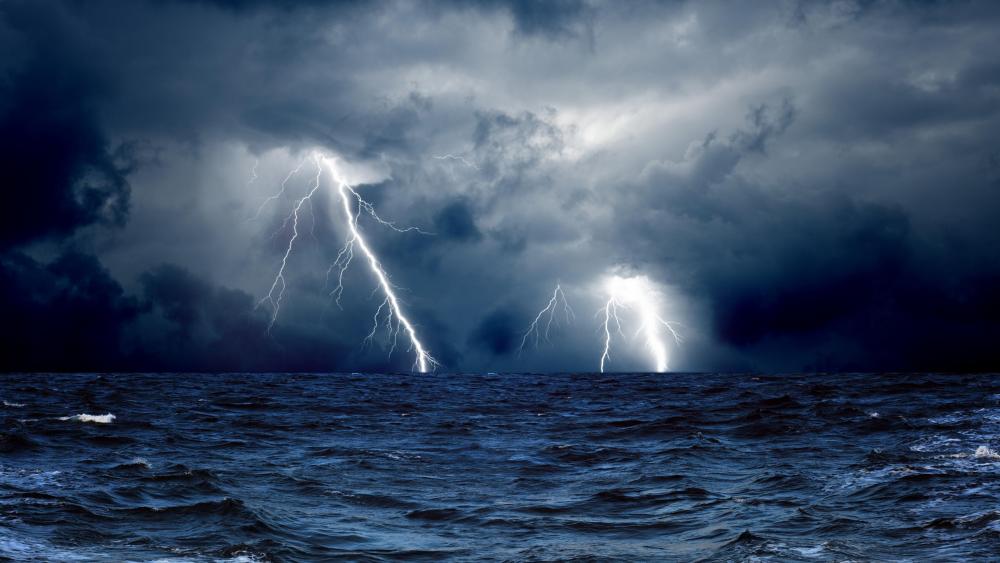 Lightning strikes over the ocean wallpaper