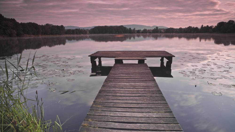Purple dawn from a wooden dock wallpaper