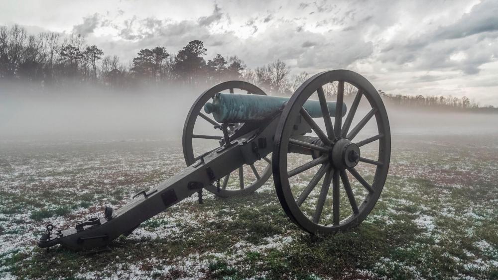 Old cannon in a foggy field wallpaper