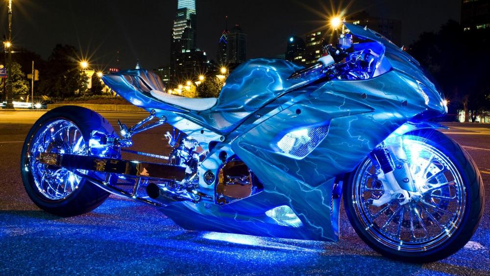 Illuminated Blue Chopper Motorcycle at Night wallpaper