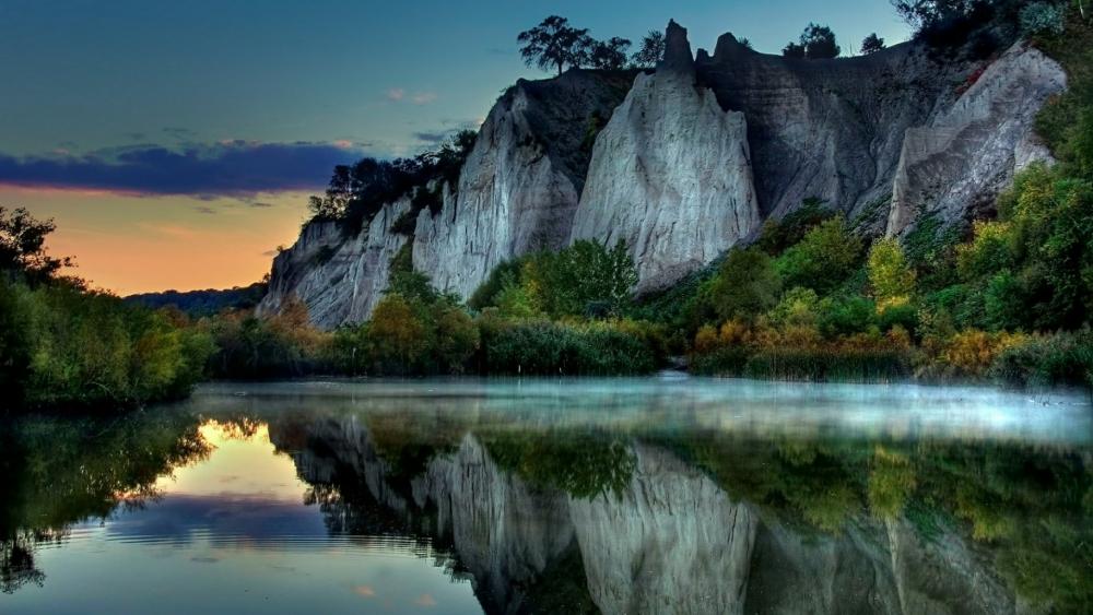 White cliff reflected in the calm lake wallpaper