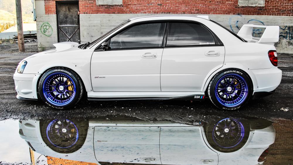 White Subaru reflected in a puddle wallpaper