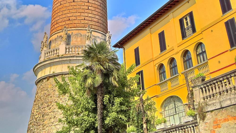 Charming Cityscape with Historical Architecture and Lush Foliage wallpaper