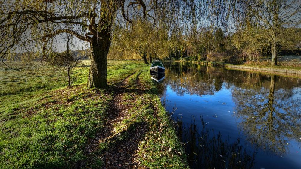 Boat on a small river wallpaper