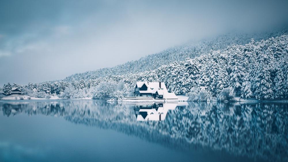 Snowy lakeside house wallpaper