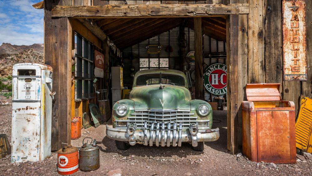 Old gas station with a vintage car wallpaper