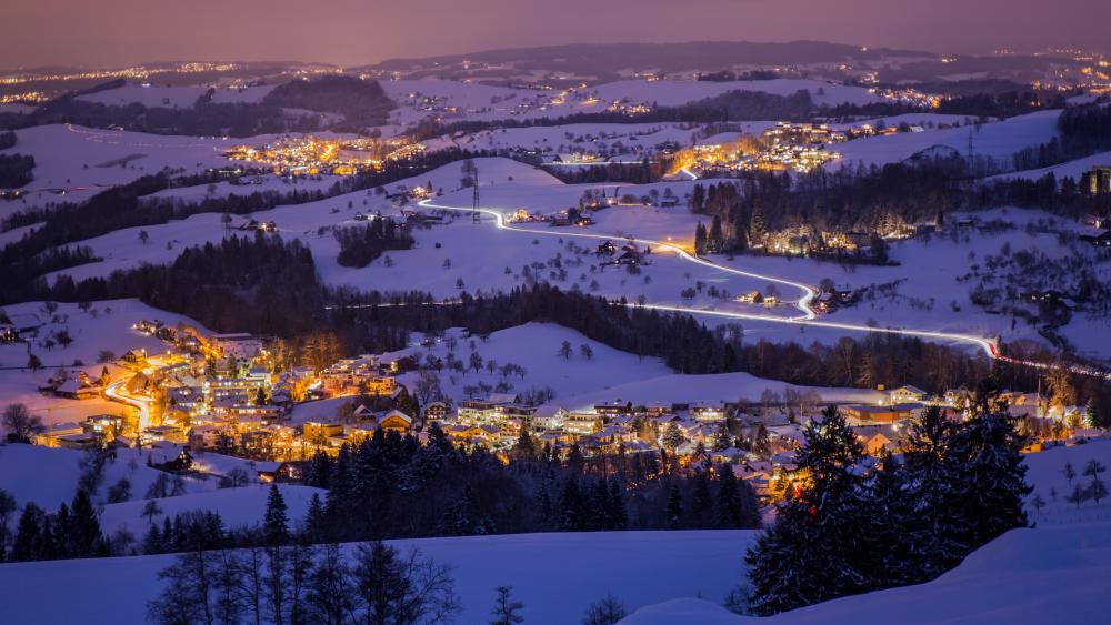 Winter Town Illuminated in Evening Glow wallpaper