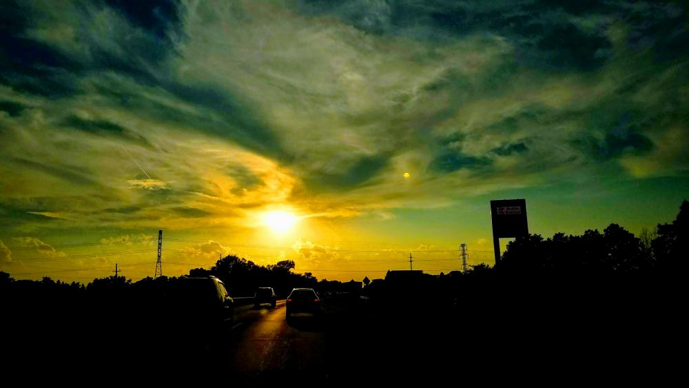 Breathtaking Sunset Over a Tranquil Roadscape wallpaper
