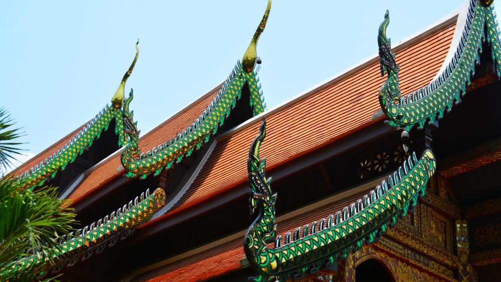 Green dragon detailed temple roof in Thailand wallpaper