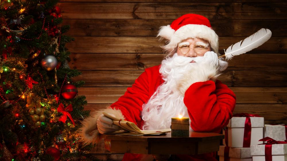 Santa Claus with gifts in his log cabin wallpaper